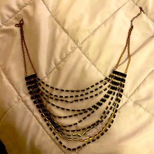 Woman’s black and gold statement necklace